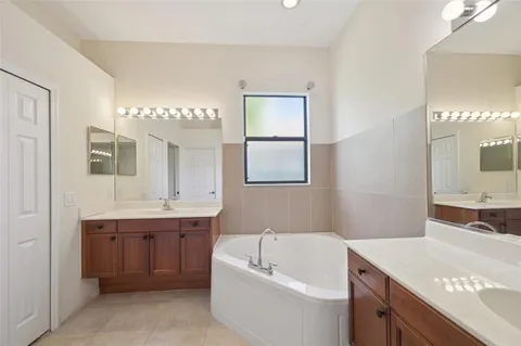 a bathroom with a double vanity sink mirror and shower