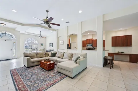 a living room with furniture ceiling fan and a rug