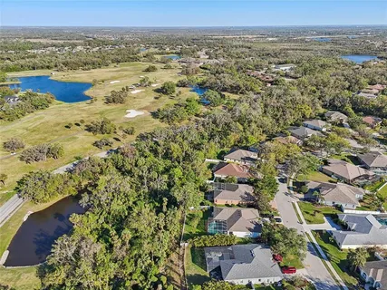 an aerial view of a residential houses with outdoor space and swimming pool