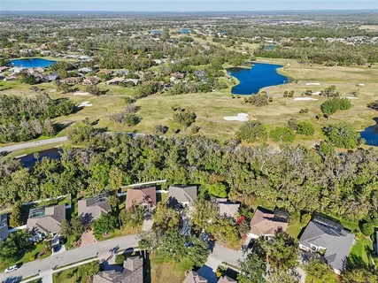 an aerial view of a house with a yard and lake view