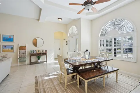 a view of a dining room with furniture and a chandelier
