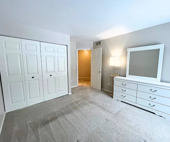 a view of cabinet and mirror in a room