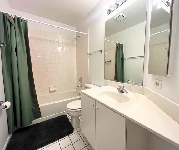 a bathroom with a sink a toilet a mirror and shower