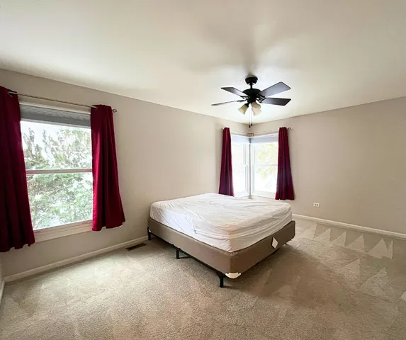 a bed room with a bed and a large window