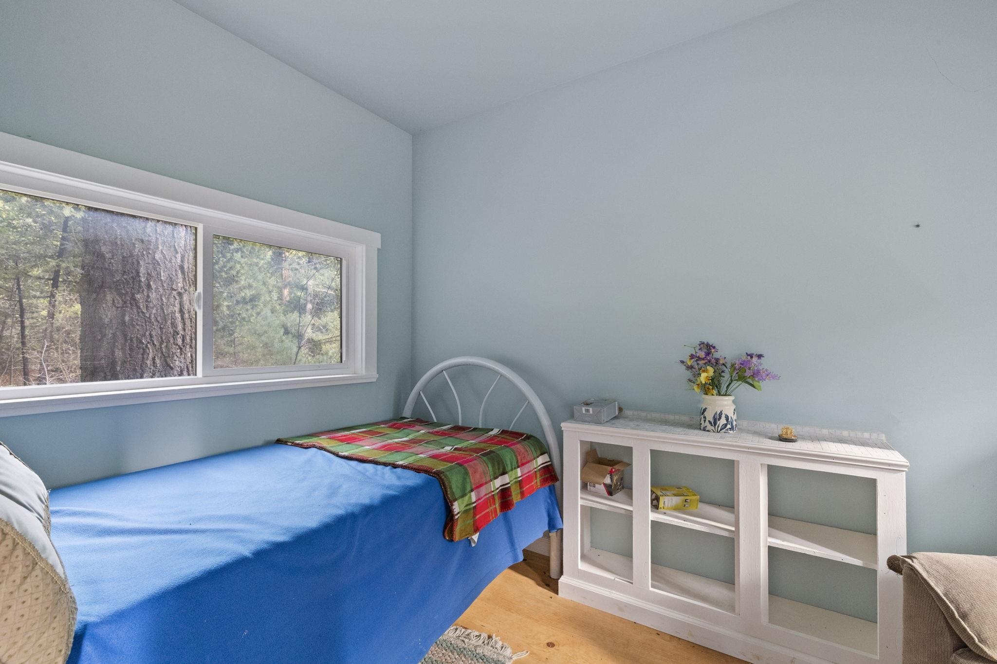 25777 Long Barn Sugar Pine Road Long Barn, CA 95335 - Photo 7 of 18 a bedroom with a bed and a window
