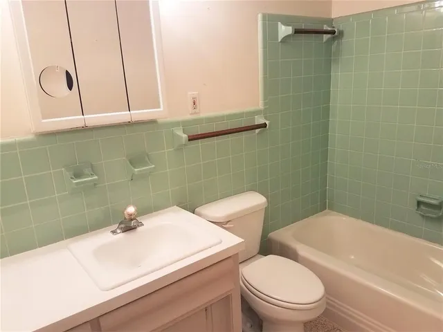 a bathroom with a mirror and a shower