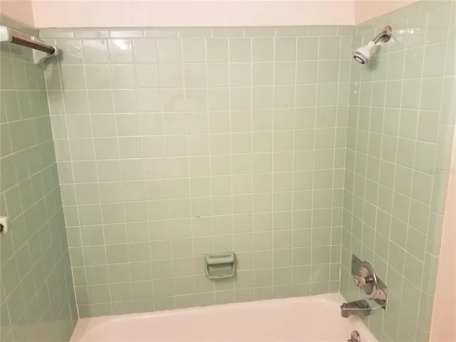 an empty room with a fan and a fan