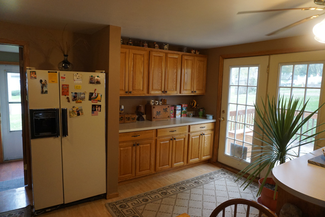 229 East 1st Street Spring Valley, IL 61362 - Photo 5 of 14 a kitchen with stainless steel appliances granite countertop a refrigerator a sink dishwasher a stove a dining table and chairs with wooden floor