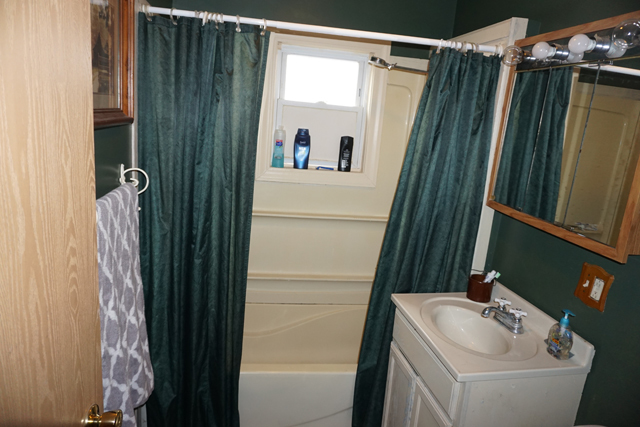 229 East 1st Street Spring Valley, IL 61362 - Photo 7 of 14 a bathroom with a sink and mirror with bathtub