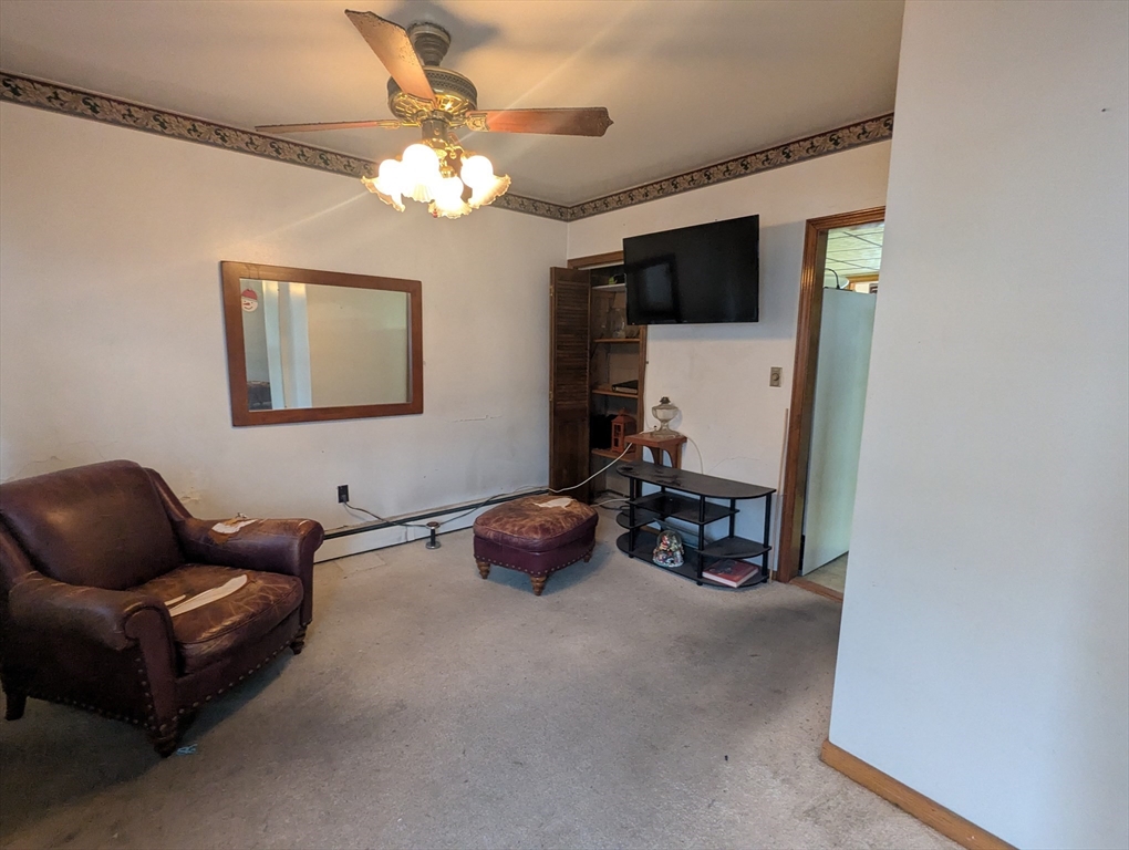 205 London Street Boston, MA 02128 - Photo 8 of 13 a living room with furniture and a chandelier