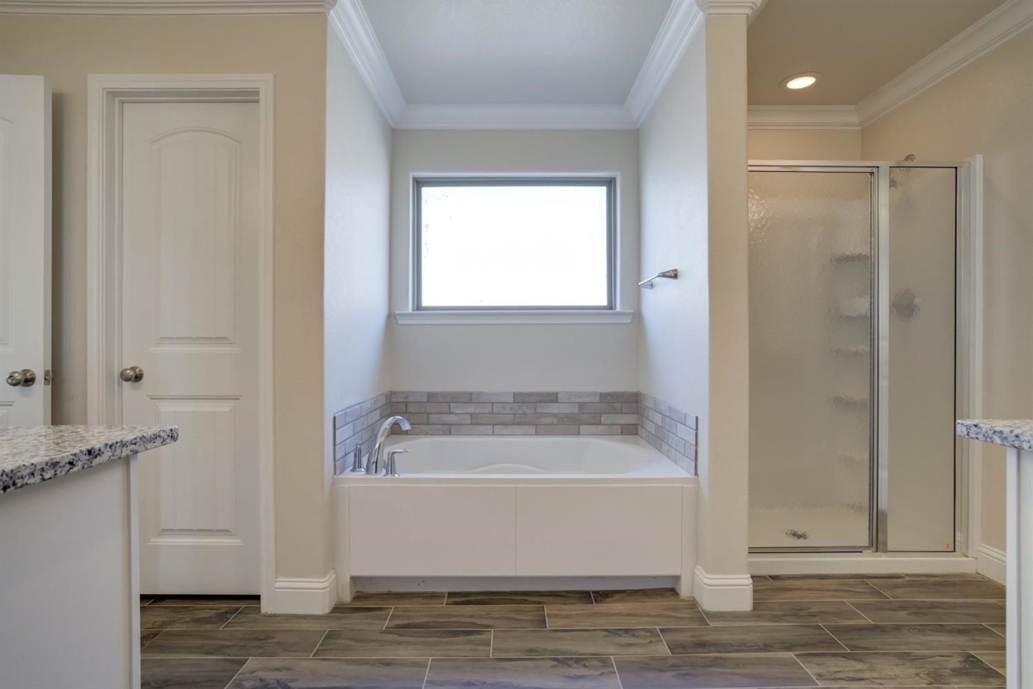 8806 Rochester Avenue Lubbock, TX 79424 - Photo 17 of 25 a bathroom with a bathtub and a shower