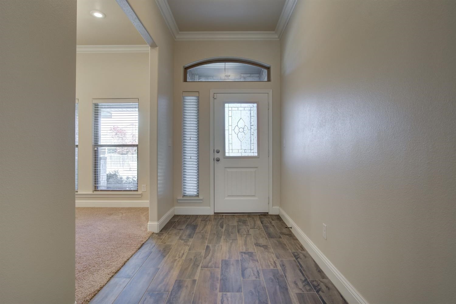 8806 Rochester Avenue Lubbock, TX 79424 - Photo 2 of 25 an empty room with wooden floor and windows