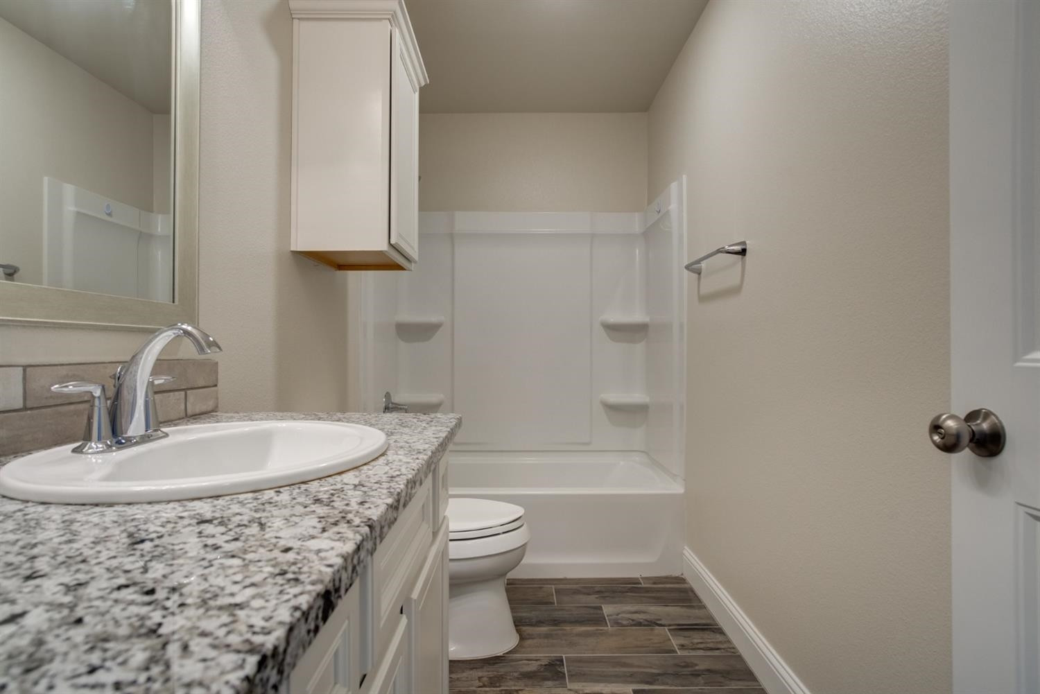 8806 Rochester Avenue Lubbock, TX 79424 - Photo 21 of 25 a bathroom with a sink a toilet and shower
