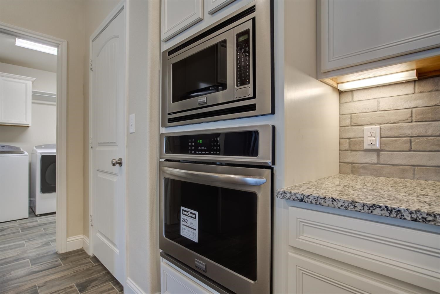 8806 Rochester Avenue Lubbock, TX 79424 - Photo 8 of 25 a kitchen with granite countertop white cabinets and stainless steel appliances