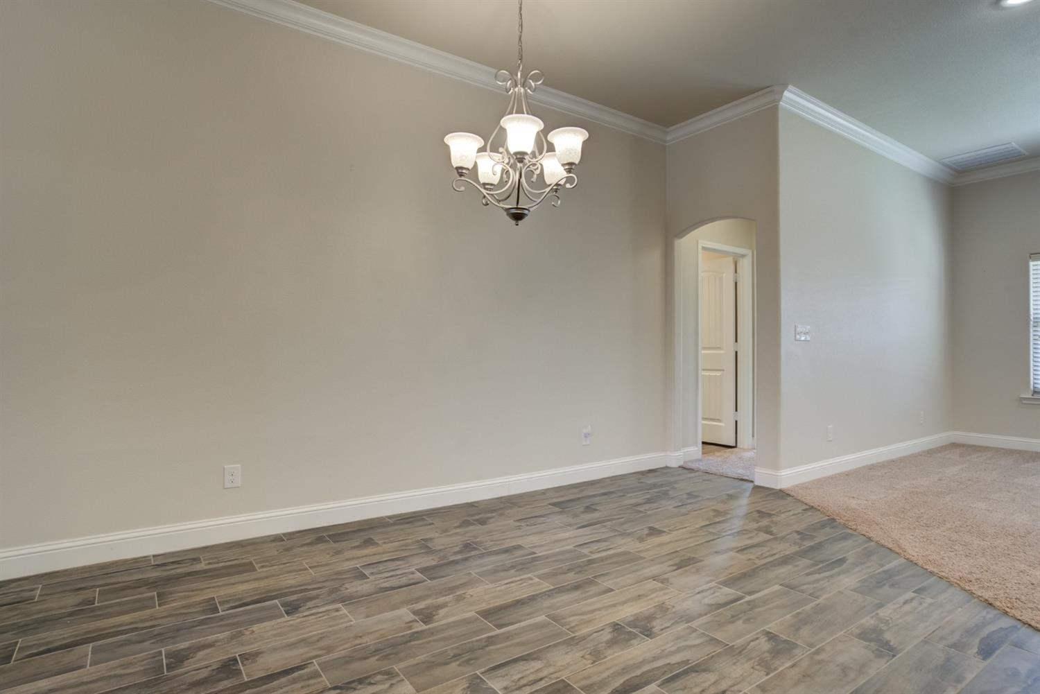 8806 Rochester Avenue Lubbock, TX 79424 - Photo 9 of 25 a view of a chandelier fan and hardwood floor