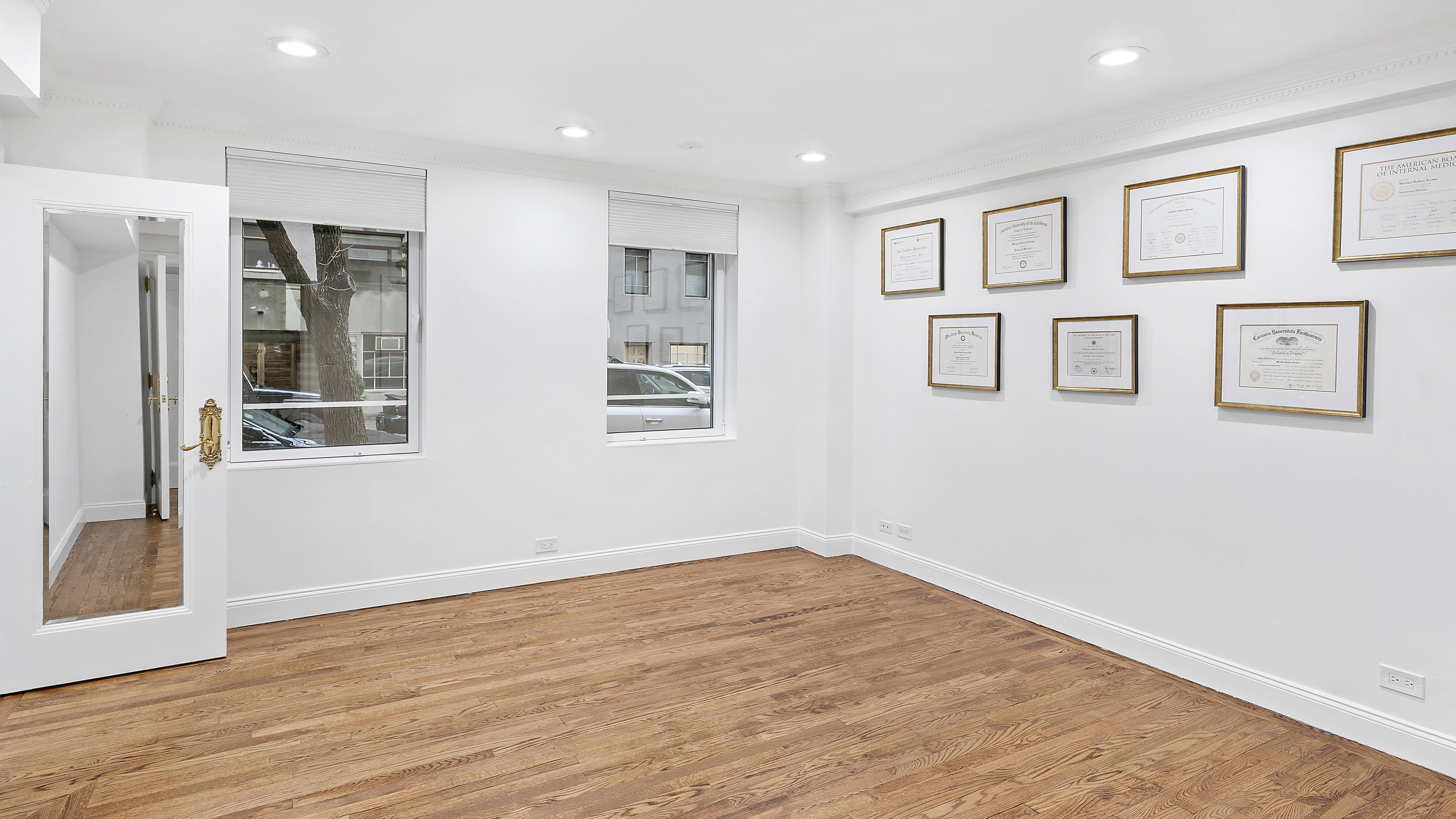 880 5th Avenue, Unit 1H Manhattan, NY 10021 - Photo 4 of 8 a view of empty room with wooden floor and fan