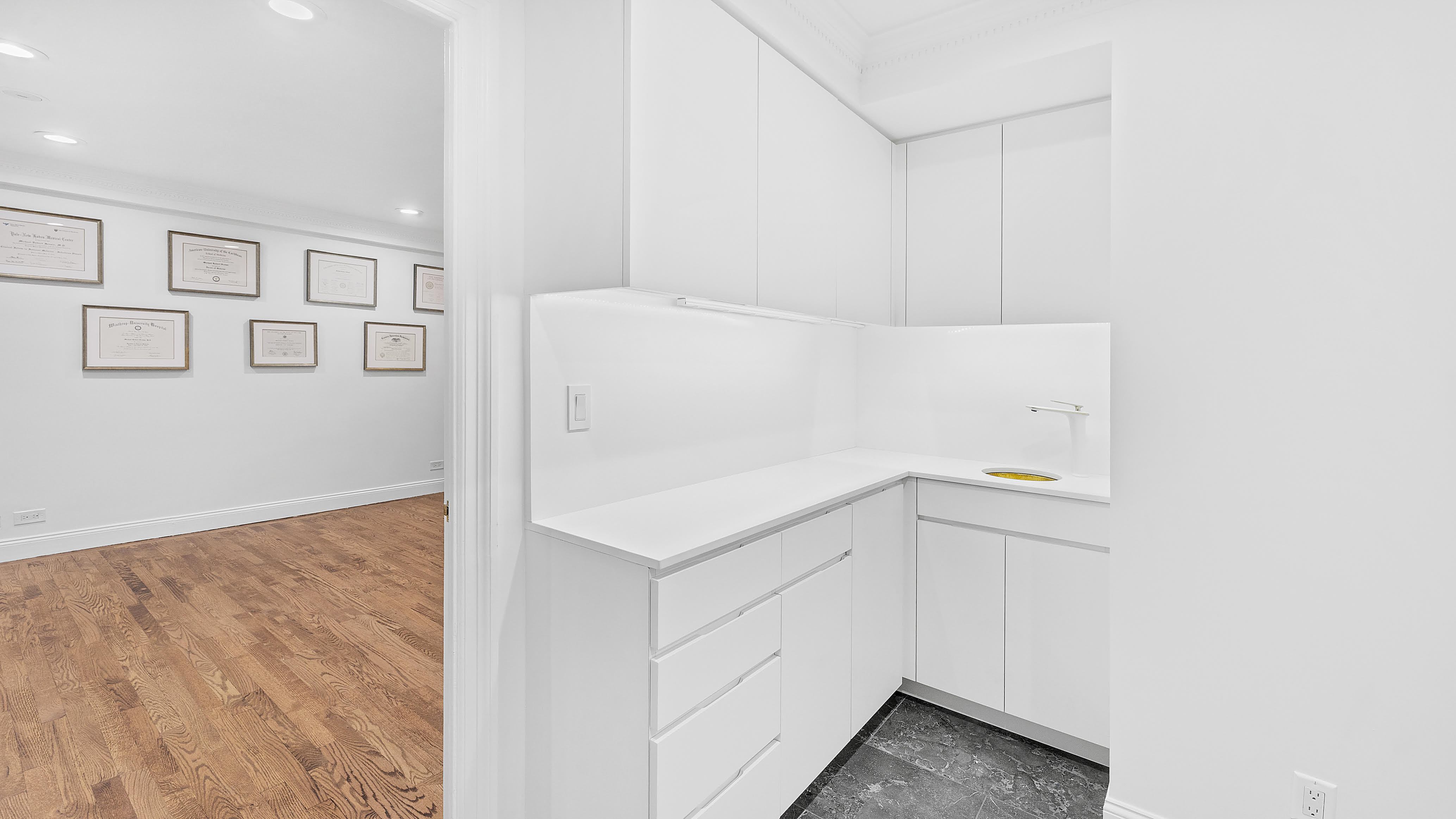 880 5th Avenue, Unit 1H Manhattan, NY 10021 - Photo 5 of 8 a utility room with cabinets washer and dryer