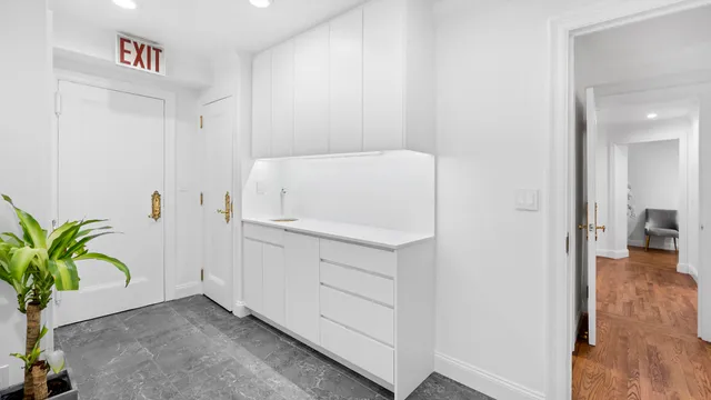 a utility room with cabinets washer and dryer
