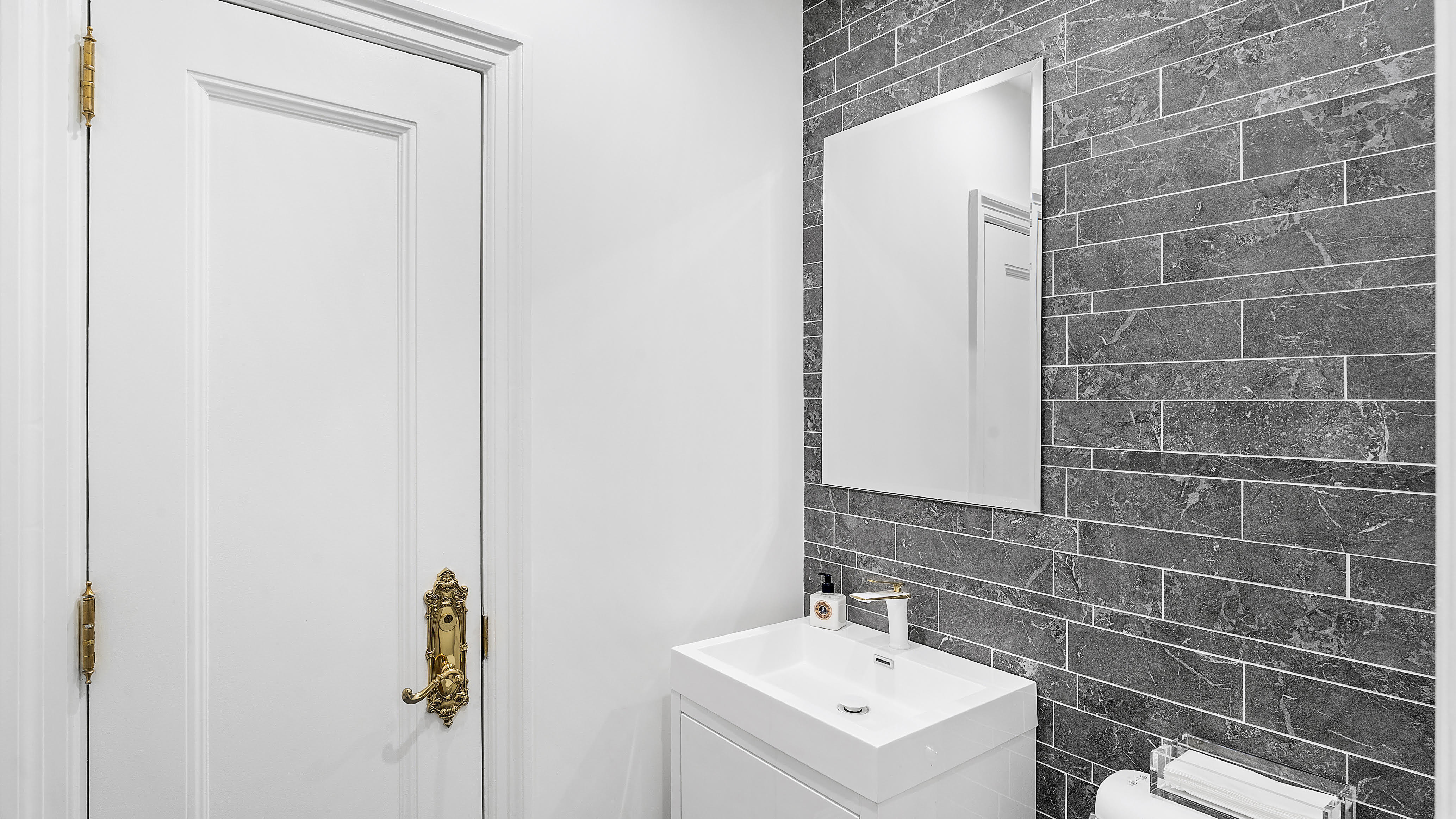 880 5th Avenue, Unit 1H Manhattan, NY 10021 - Photo 7 of 8 a bathroom with a sink a toilet and mirror
