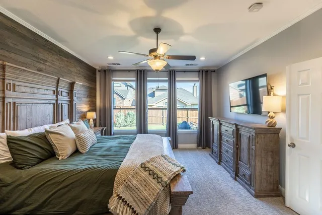 a spacious bedroom with a balcony a bed and glass walk in closet