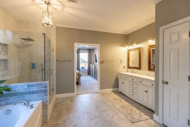 a spacious bathroom with a granite countertop sink mirror and shower