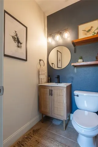 a bathroom with a toilet a sink and mirror