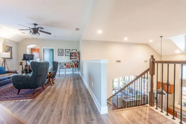 a living room with furniture and a wooden floor