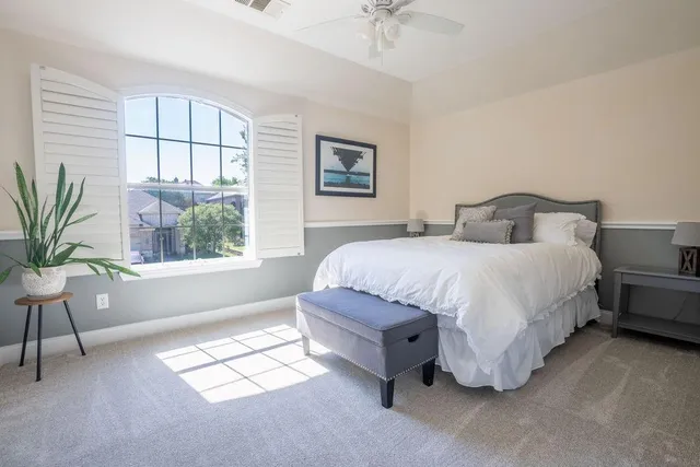a living room with furniture a flat screen tv and a window