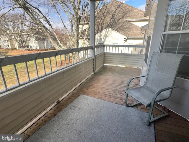 a view of a room with wooden floor and windows
