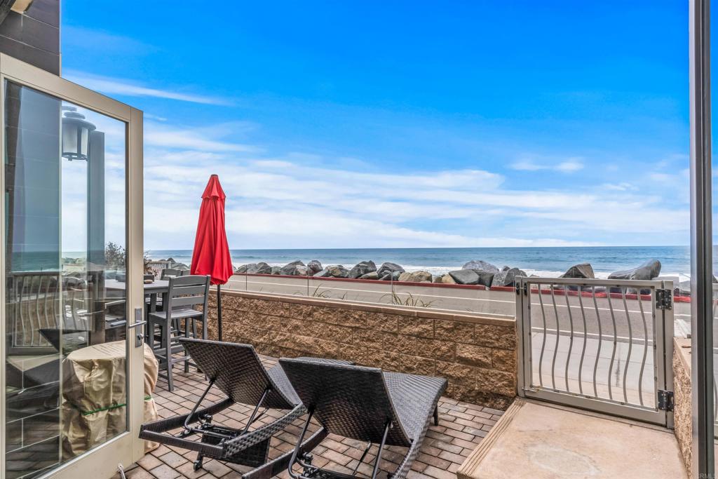 700 South The Strand, Unit 102 Oceanside, CA 92054 - Photo 1 of 25 a view of a balcony with chair and iron fence