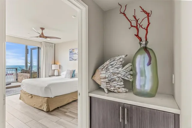 a bedroom with a large bed and a chandelier