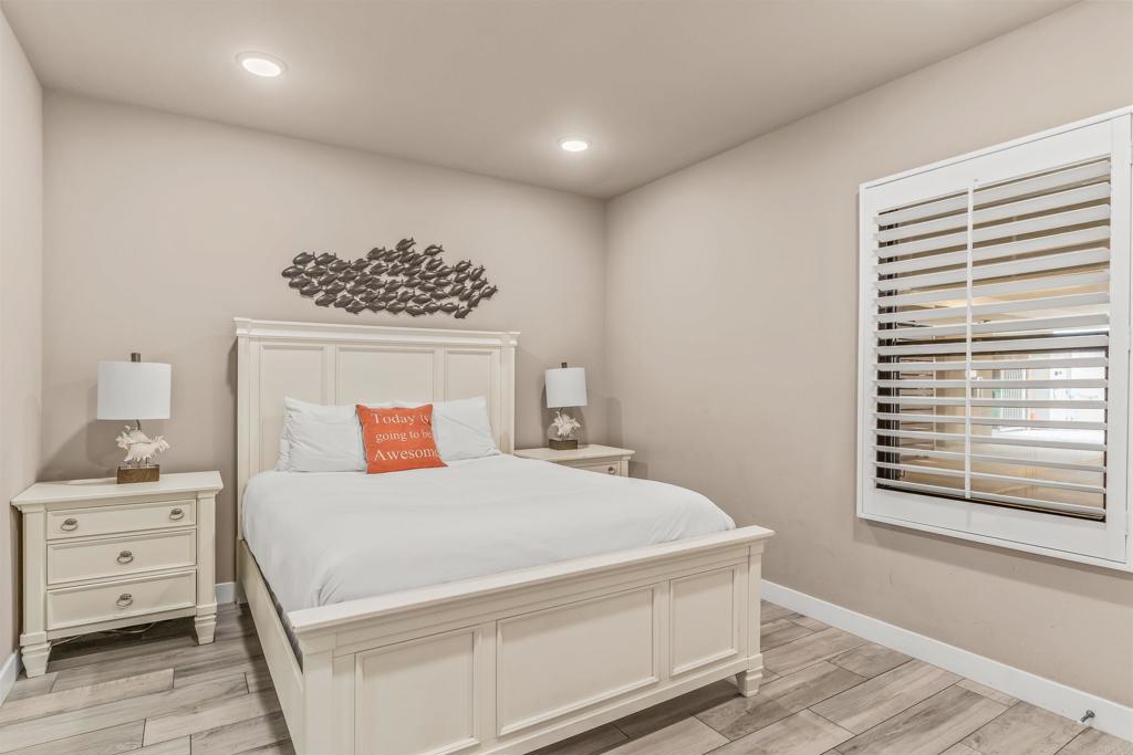 700 South The Strand, Unit 102 Oceanside, CA 92054 - Photo 19 of 25 a bedroom with a bed and a window