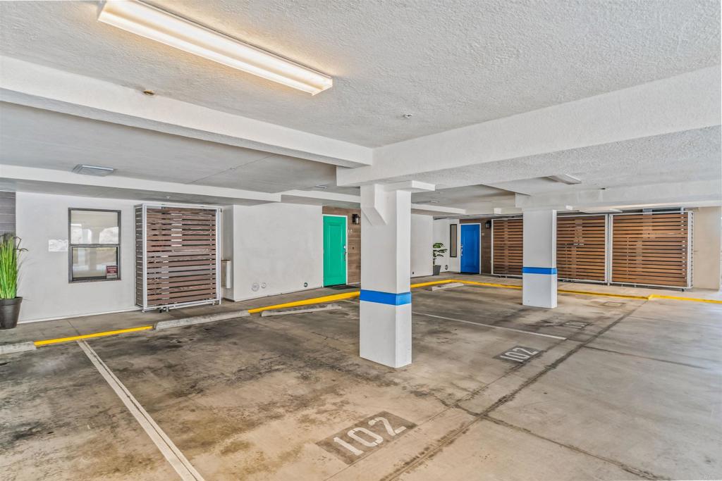 700 South The Strand, Unit 102 Oceanside, CA 92054 - Photo 25 of 25 a view of a house with large parking space and windows