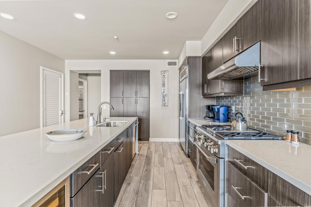 700 South The Strand, Unit 102 Oceanside, CA 92054 - Photo 7 of 25 a kitchen with stainless steel appliances a sink stove and cabinets