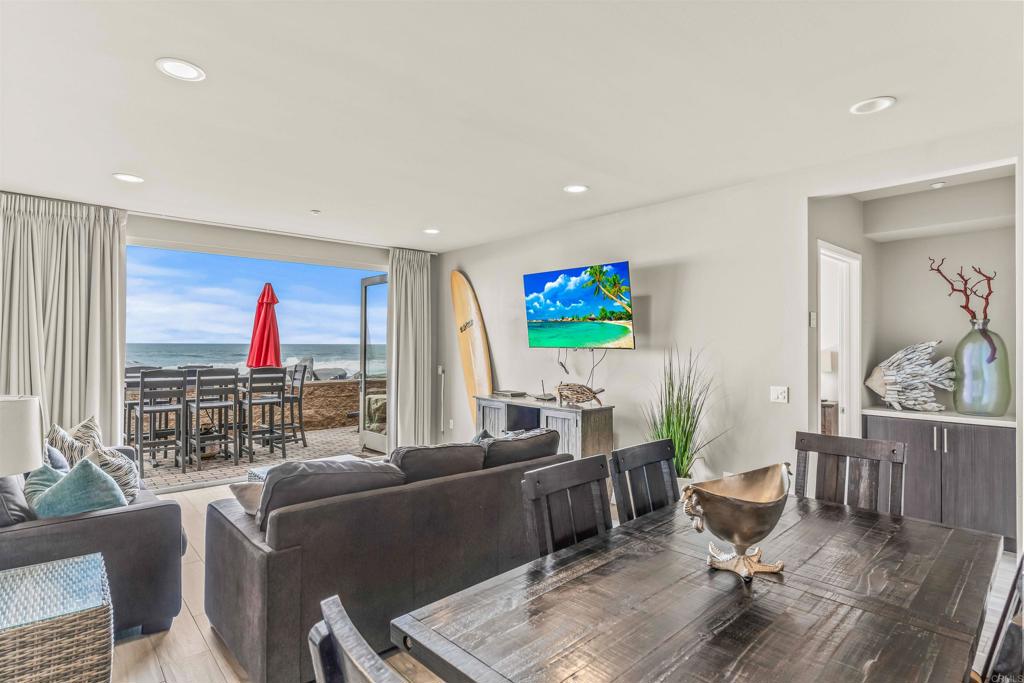 700 South The Strand, Unit 102 Oceanside, CA 92054 - Photo 9 of 25 a living room with furniture kitchen view and a window
