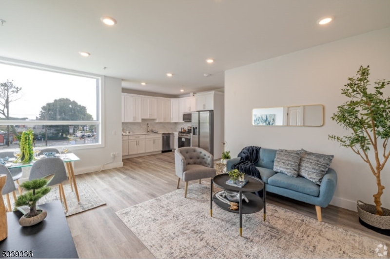 141 Crooks Avenue, Unit 501 Clifton, NJ 07011 - Photo 2 of 7 a living room with furniture and a large window