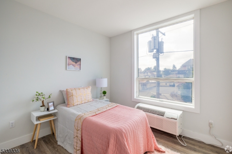 141 Crooks Avenue, Unit 501 Clifton, NJ 07011 - Photo 4 of 7 a bedroom with a bed and a window