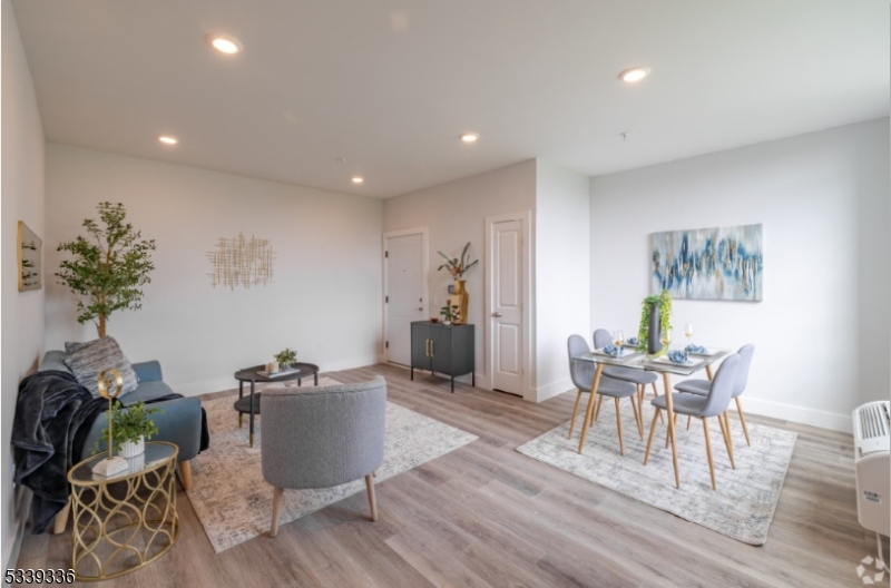 141 Crooks Avenue, Unit 501 Clifton, NJ 07011 - Photo 6 of 7 a workspace with furniture and wooden floor