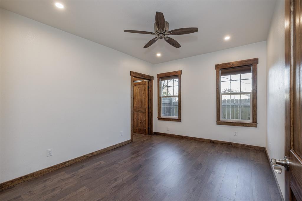 217 Houston Street Sulphur Springs, TX 75482 - Photo 17 of 35 a view of an empty room with wooden floor and a window