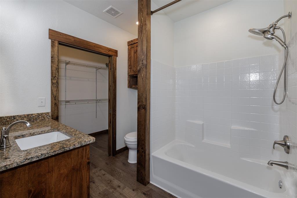 217 Houston Street Sulphur Springs, TX 75482 - Photo 18 of 35 a bathroom with a granite countertop sink toilet and shower