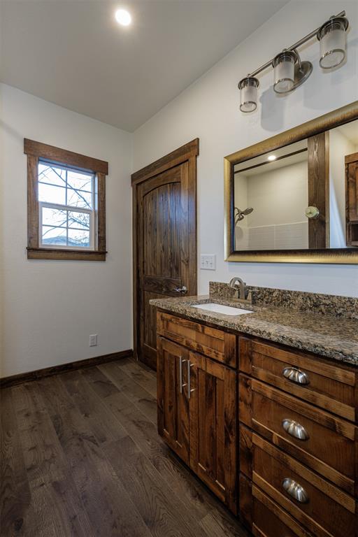217 Houston Street Sulphur Springs, TX 75482 - Photo 19 of 35 a bathroom with a sink and a mirror