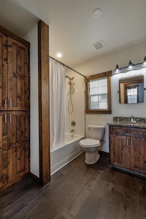 217 Houston Street Sulphur Springs, TX 75482 - Photo 21 of 35 a bathroom with a toilet a sink and a bathtub