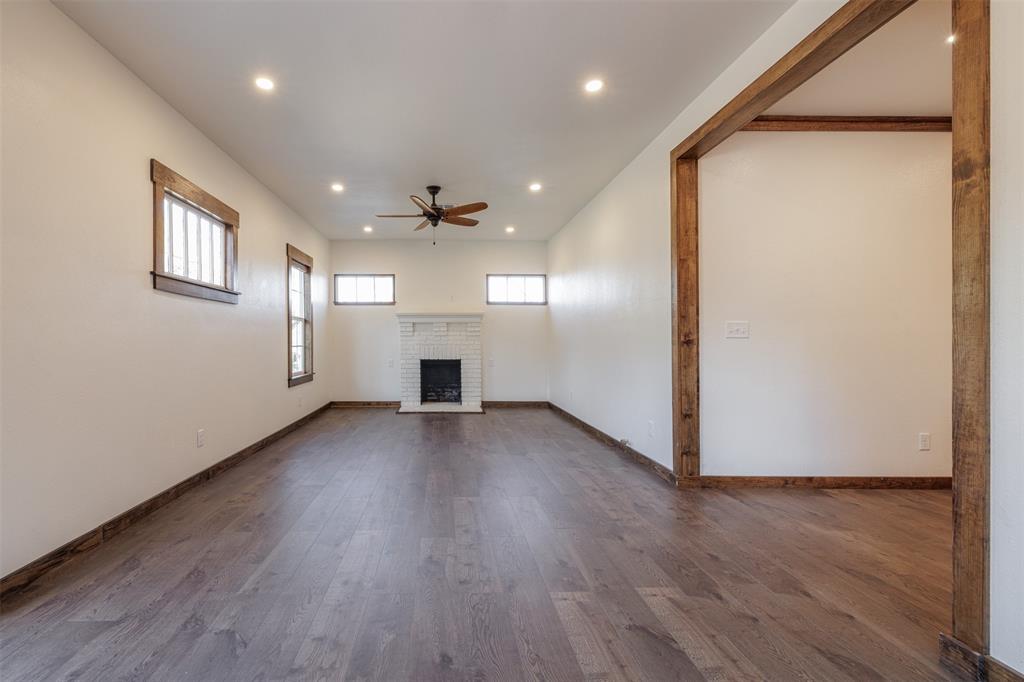 217 Houston Street Sulphur Springs, TX 75482 - Photo 9 of 35 an empty room with wooden floor and windows
