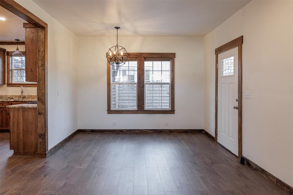 217 Houston Street Sulphur Springs, TX 75482 - Photo 10 of 35 an empty room with wooden floor and windows