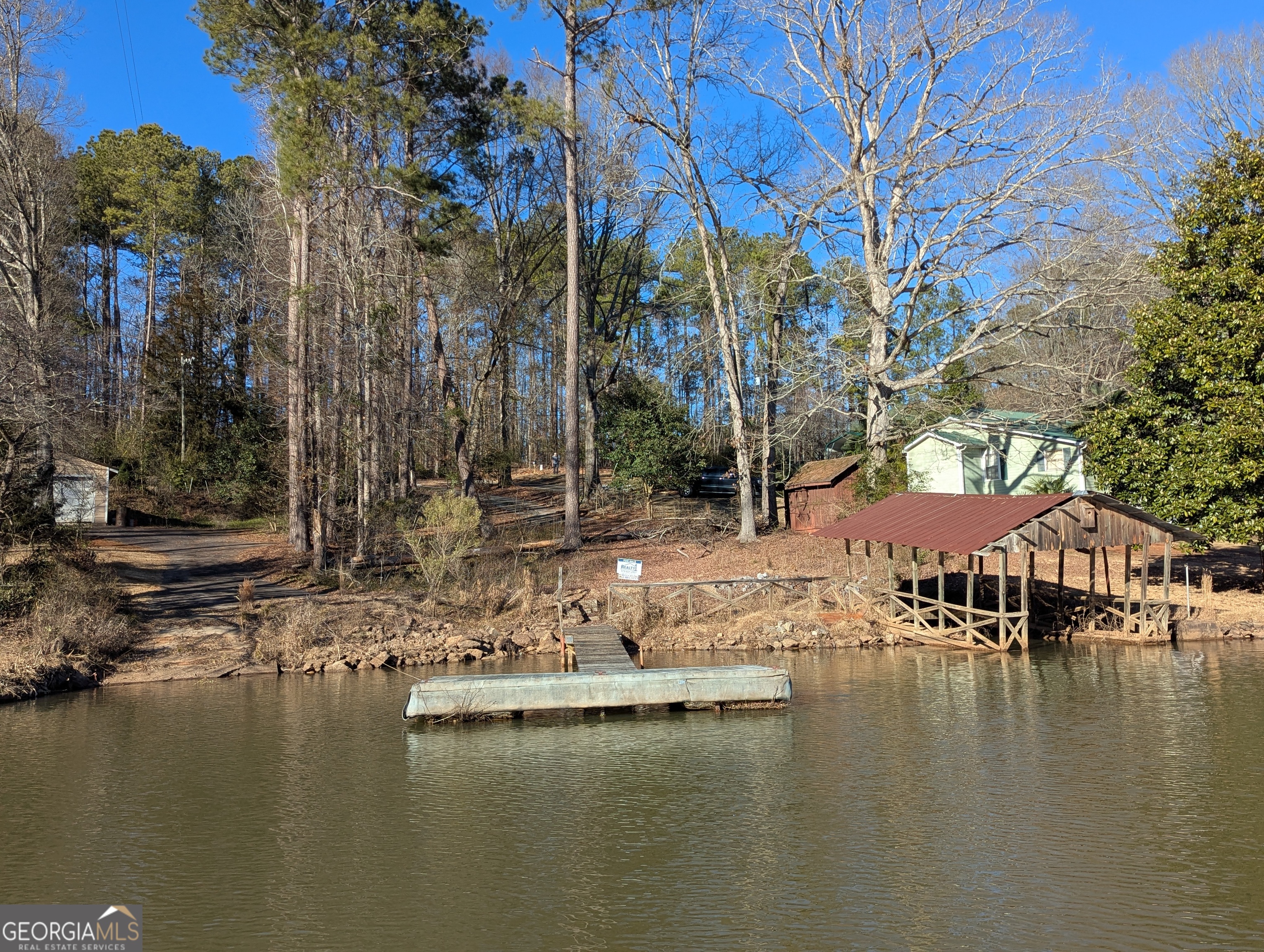 a view of house with outdoor space and lake view