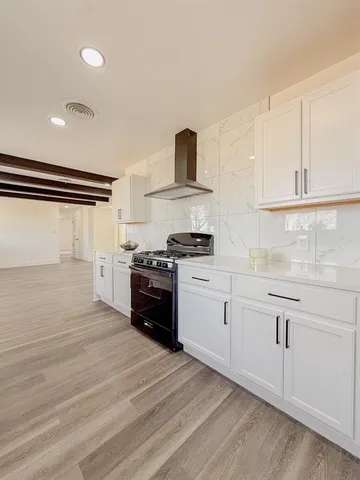 a kitchen with granite countertop a stove and a refrigerator