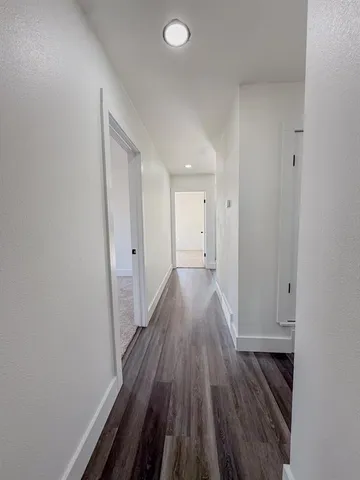a view of hallway with wooden floor