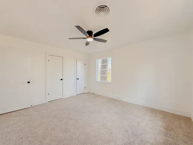 an empty room with a empty space and a ceiling fan