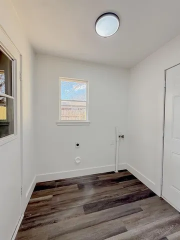 a view of a room with wooden floor and window