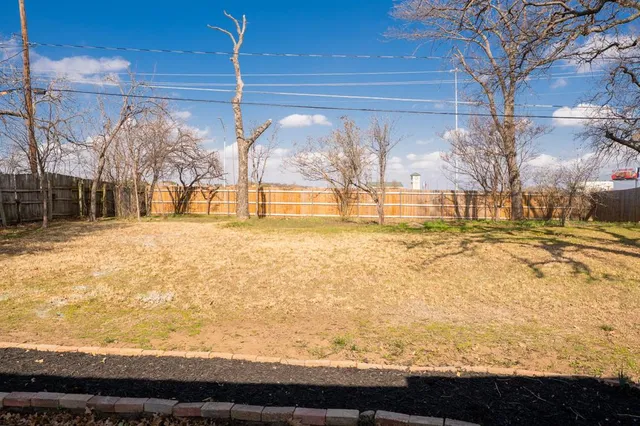 a view of a yard with a tree